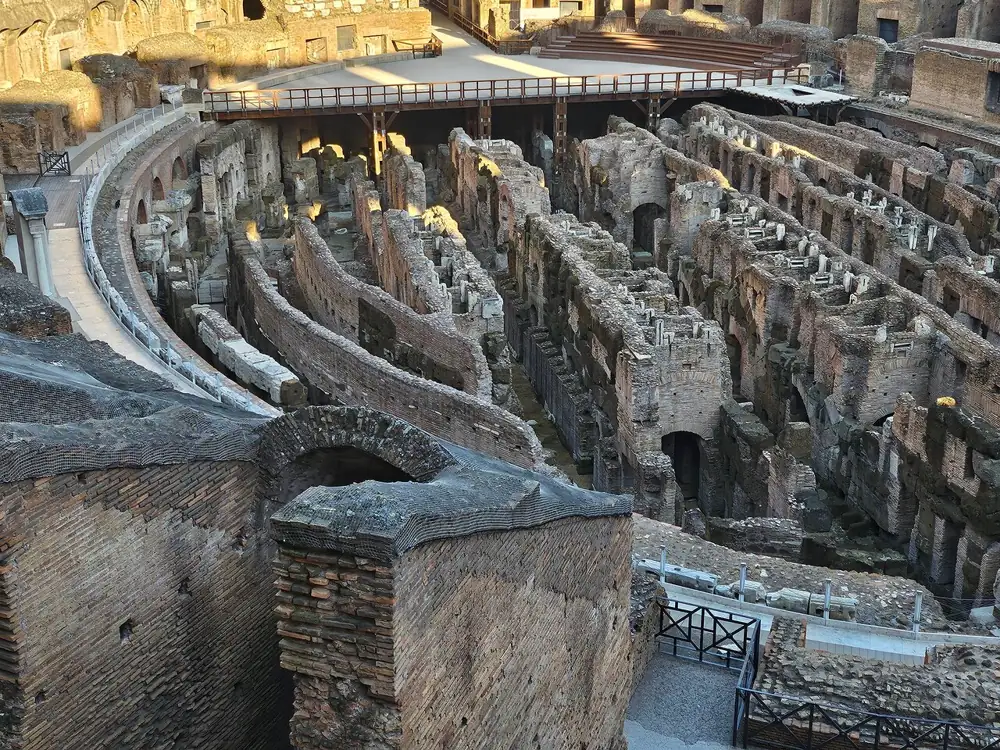 The hypogeum walls seen from the edge of the arena platform in evening light